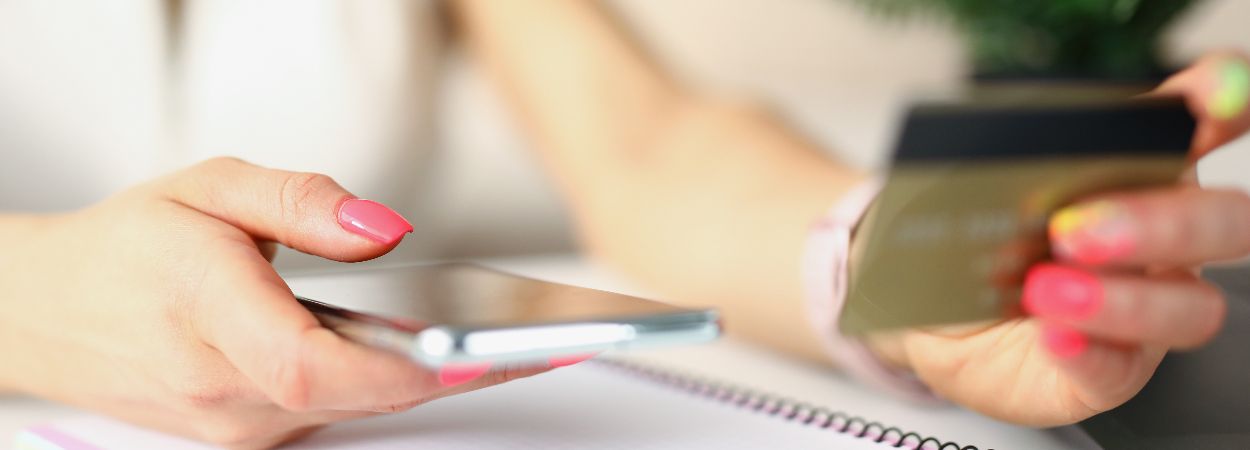 Closeup female person paying services goods smartphone with credit card woman (1)
